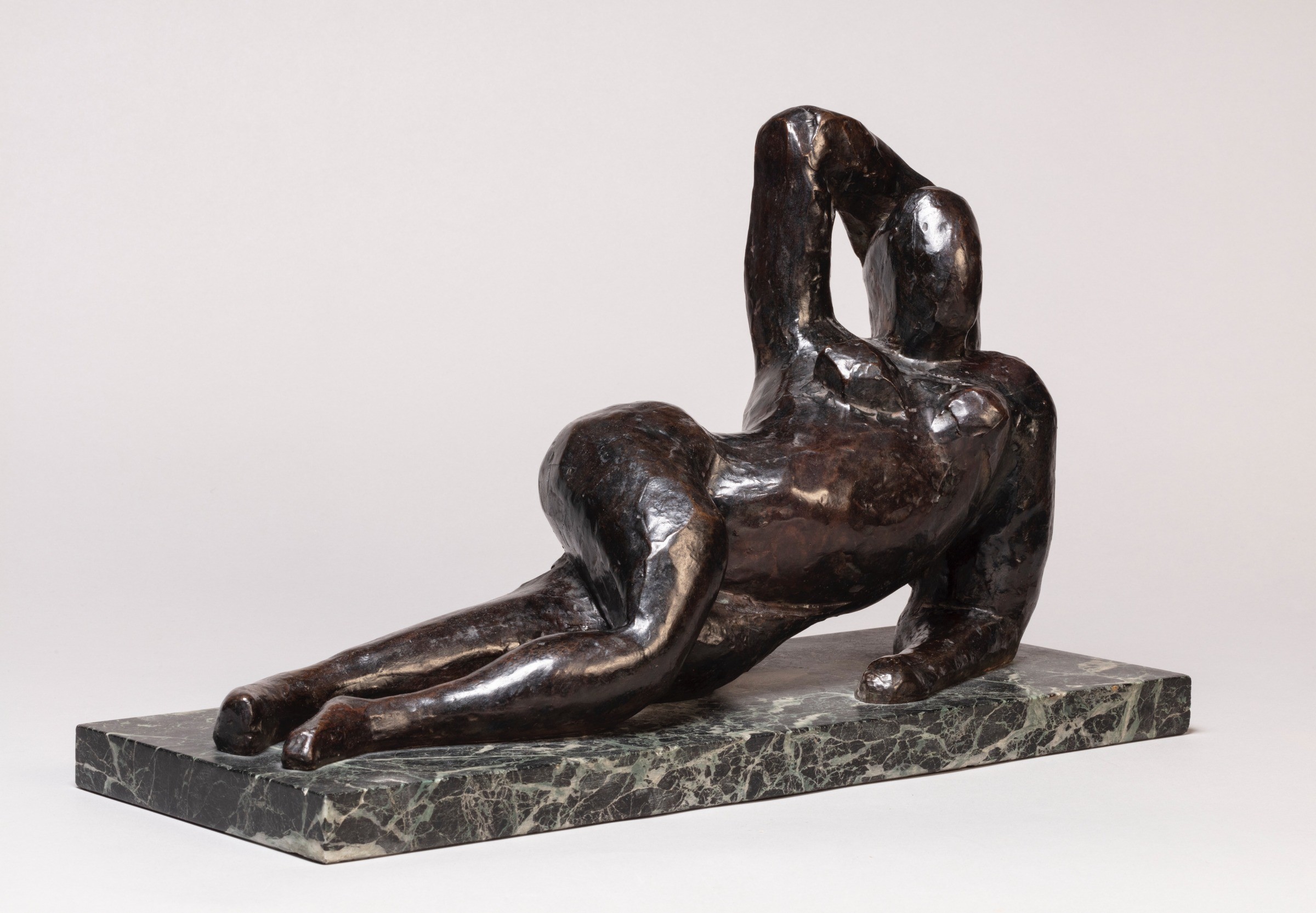 Henri Matisse bronze of a reclining figure, arm raised, on a green marble base